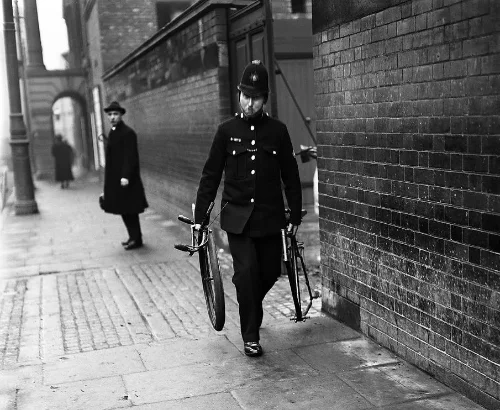 Police officer carrying bicycle parts retrieved from canal in the green bicycle case